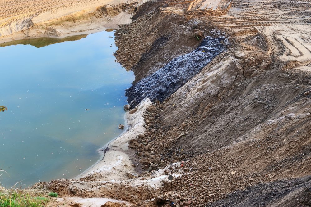 Environmental field technician recording remediation and groundwater monitoring data for regulatory audit reports in 2026