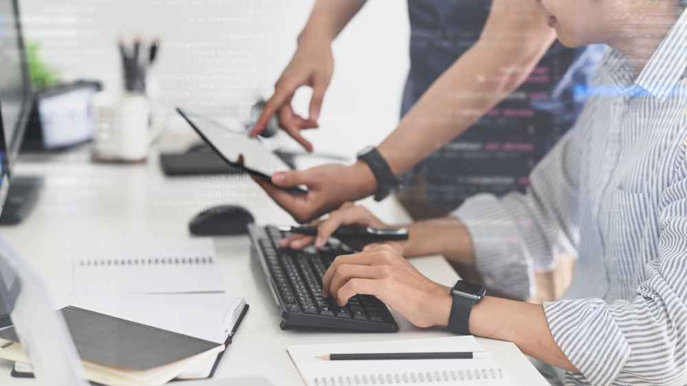 CEO evaluating custom .NET versus off-the-shelf SaaS in 2026, weighing the decision framework on screen with business operational data